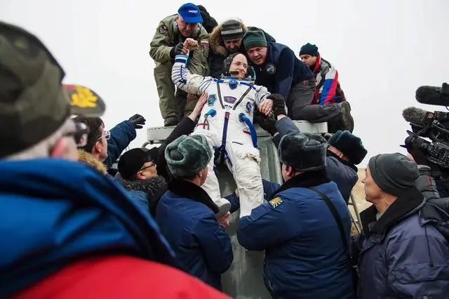 Scott was helped out of the spacecraft by ground staff