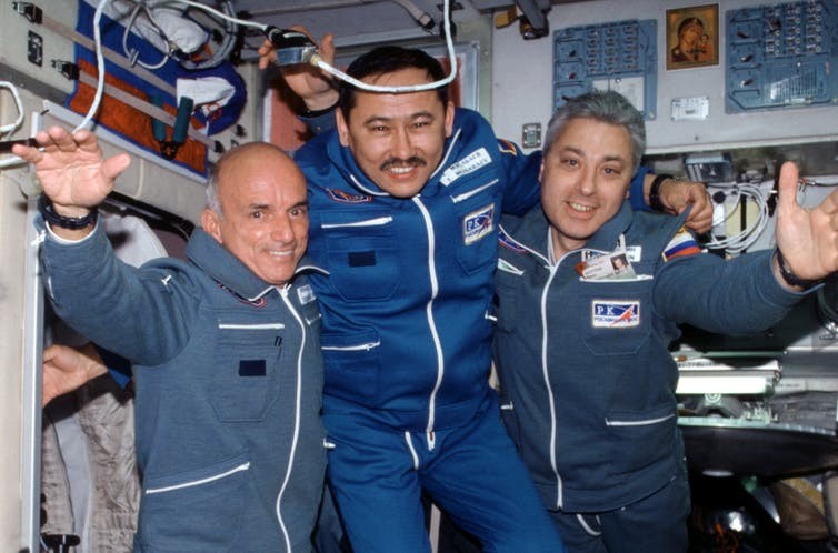 Denis Tito (left) poses with two Russian cosmonauts, the first ordinary citizen to go into space, staying on the International Space Station for more than a week.