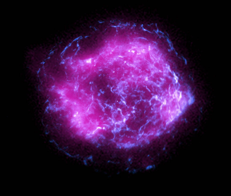 This image of the supernova remnant Cassiopeia A combines some of the first X-ray data collected by NASA’s Imaging X-ray Polarimetry Explorer, shown in magenta, with high-energy X-ray data from NASA’s Chandra X-Ray Observatory, in blue.